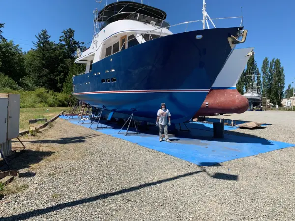 worker doing coating at boat